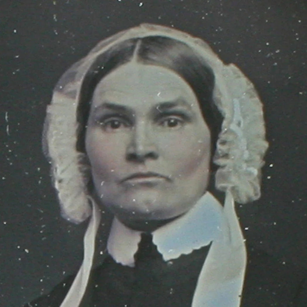 WOMAN, STRONG CHEEK BONES, BONNET. TINTED 6TH PLATE DAGUERREOTYPE, FULL CASE.