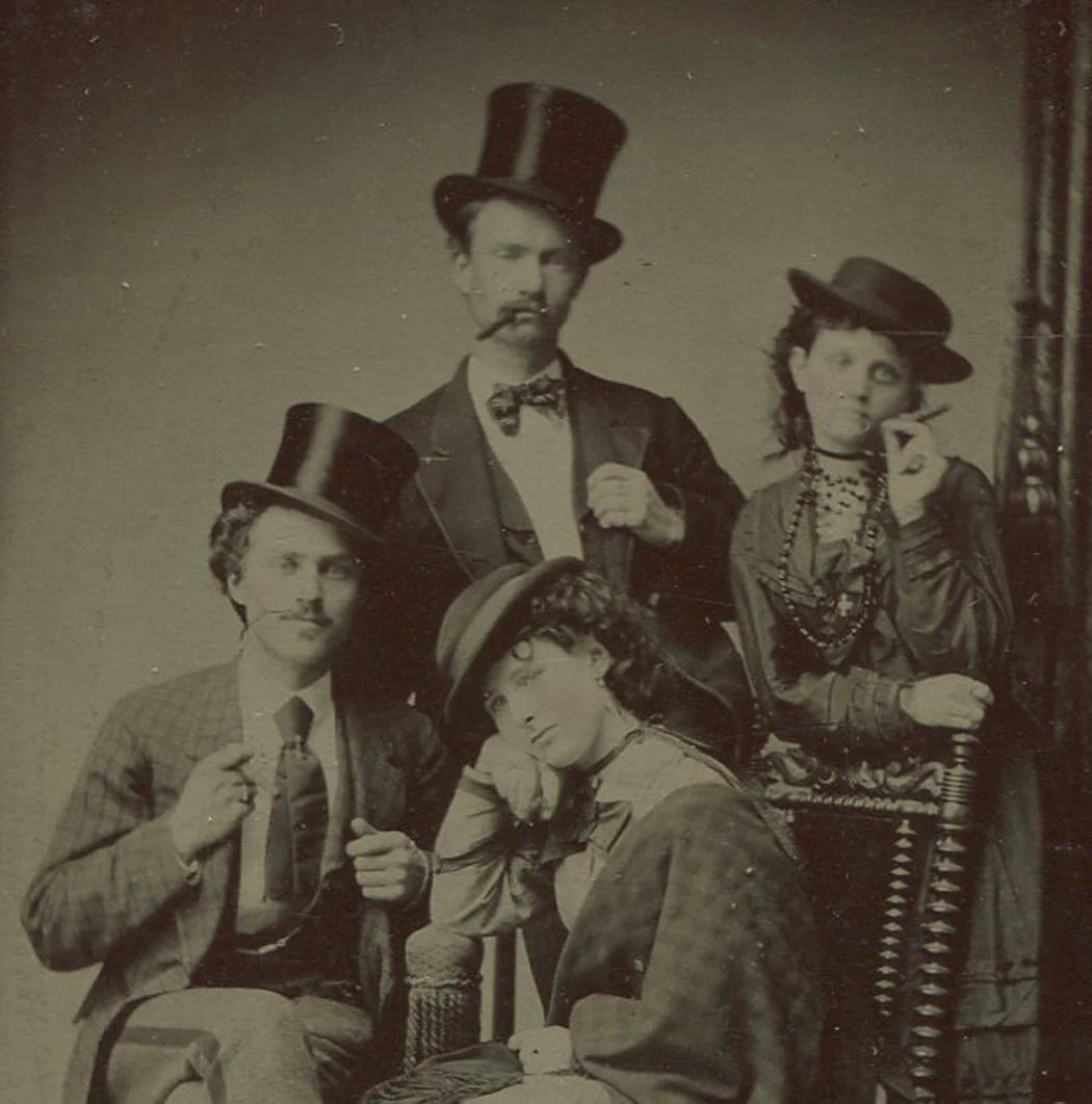 MEN, WOMEN IN HATS AND HOLDING CIGARS. THEATRICAL FLAVOR TO TINTED TINTYPE.