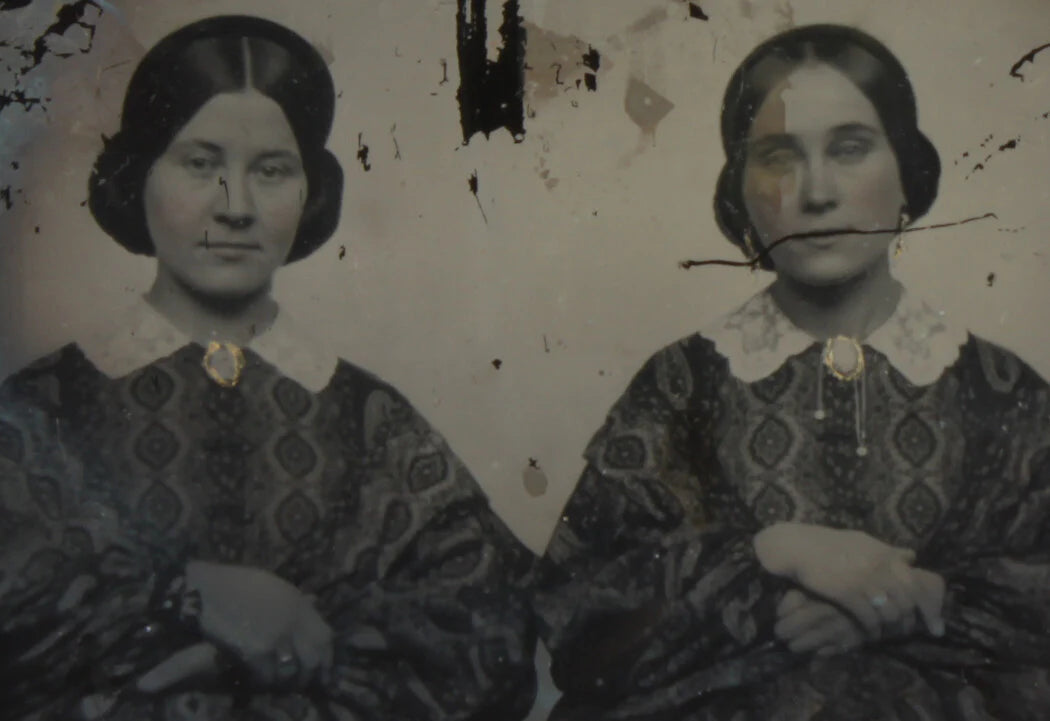 SISTERS IN MATCHING DRESSES. TINTED AMBROTYPE, RUBY GLASS, 6TH PLATE, NO CASE.