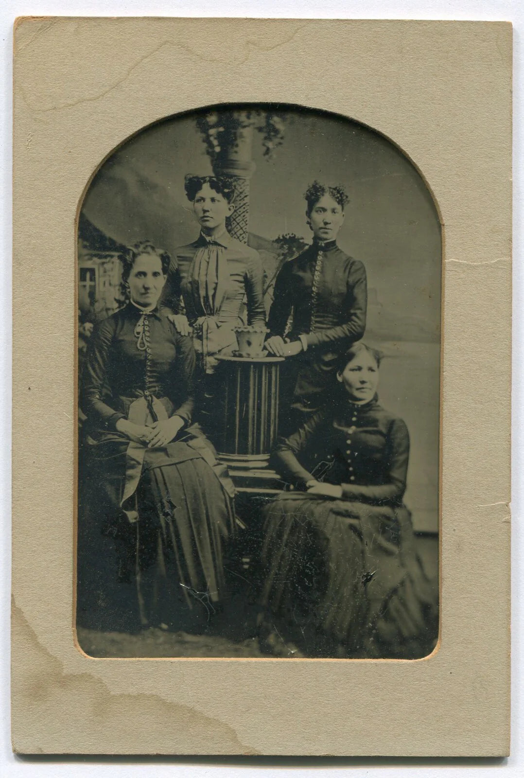 FOUR WOMEN, TWINS W/UNFORTUNATE HAIRSTYLE. TINTYPE IN PAPER MAT, 6X4 IN.
