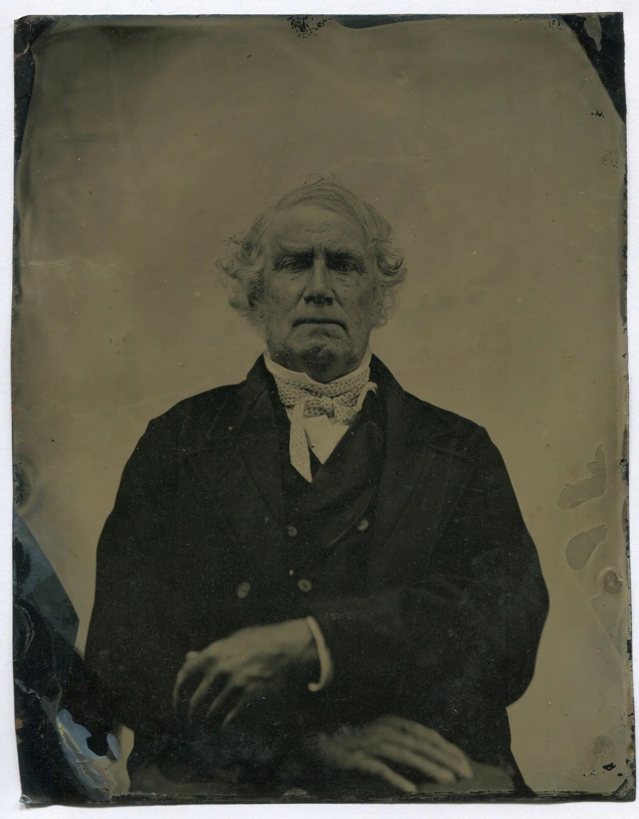 OLD MAN, HIGH COLLAR, HANDS CROSSED ON LAP. TINTYPE, 6.5 X 8.5 IN.