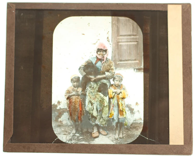 COLOR PHOTO ON GLASS OF INDIGENOUS MOTHER & CHILDREN IN BRIGHT CLOTHING
