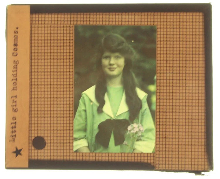 AUTOCHROME OF SMILING YOUNG GIRL IN BLUE DRESS WITH COSMOS FLOWERS