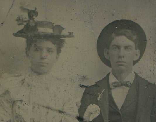 Tintype Photograph Couple Seated with Hands Folded, Hats Balanced on Heads