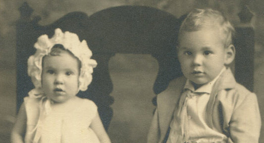 VERY YOUNG SIBLINGS,RELUCTANT POSE. B W PHOTO IN FOLDER.