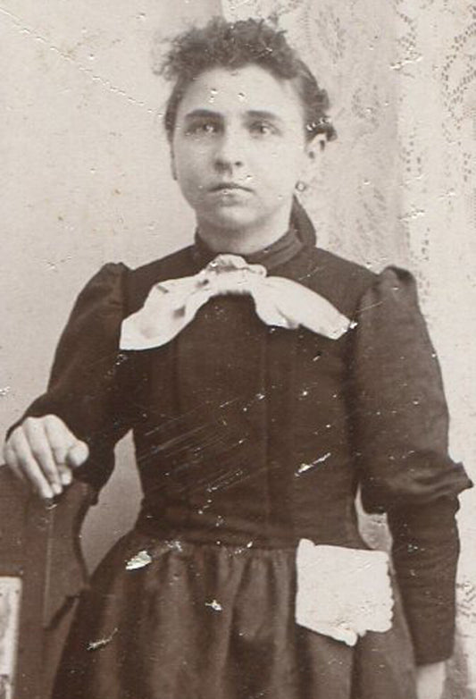 YOUNG WOMAN W/HANKEY PINNED TO SKIRT.