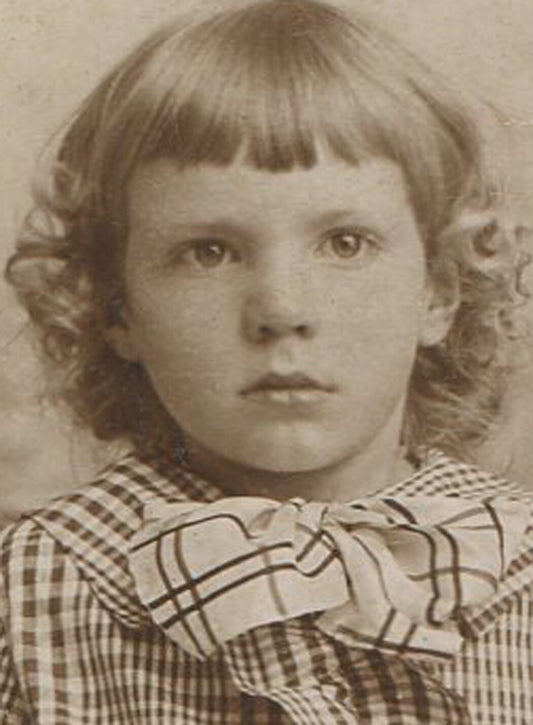 YOUNG GIRL IN PLAID DRESS REALIZING SHE HAS NO STYLE. WARE, MASS.