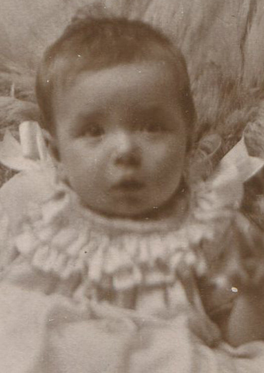 BABY SEATED ON FUR RUG, SLEEPY LOOK. CABINET CARD.