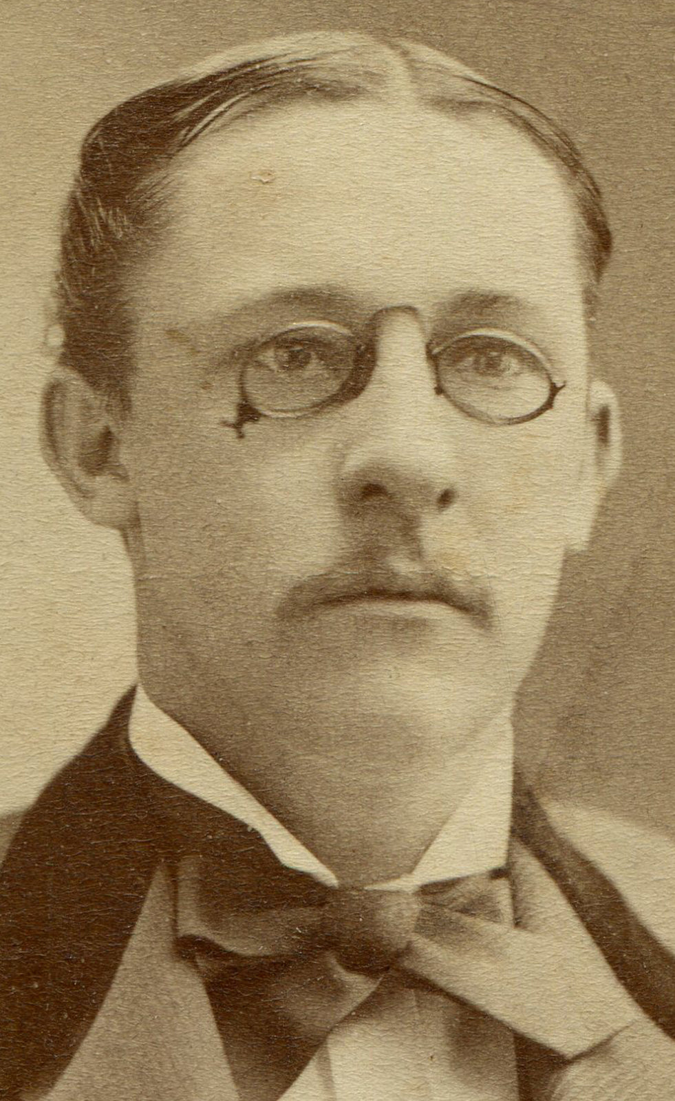MAN WEARING NOSE GLASSES, VELVET COLLAR, BOW TIE. CDV. ROCK ISLAND, ILL.