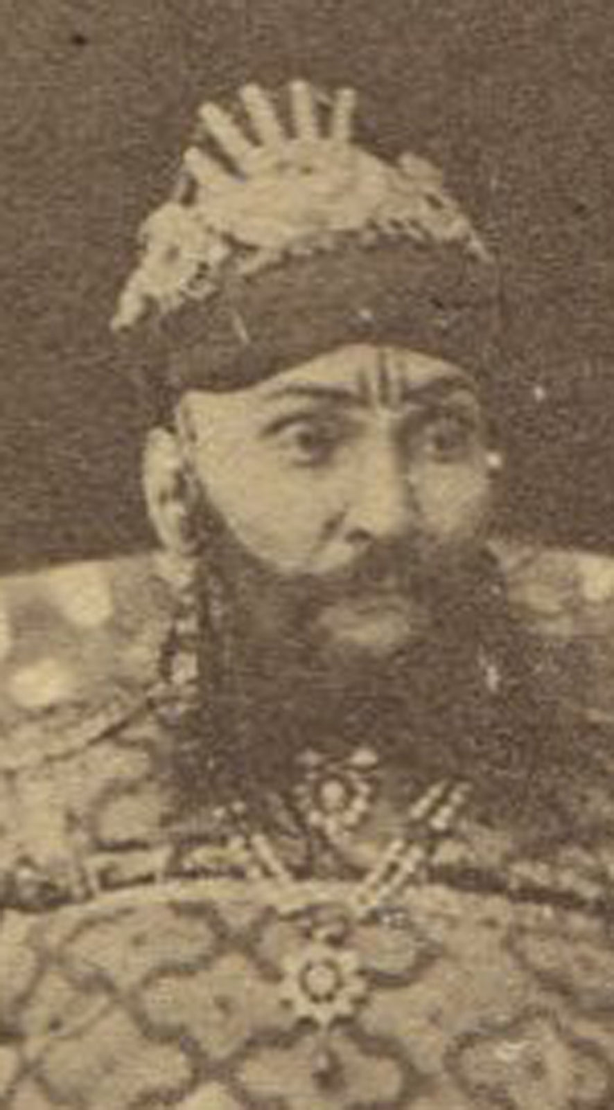 MAN WITH SWORD, TRADITIONAL DRESS SEATED ON PATTERN RUG , 19TH CEN. INDIA. CDV.