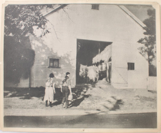 YOUNG COUPLE ENTERING BARN FOR A ROLL IN THE HAY. 14 X 17 SILVER PRINT.