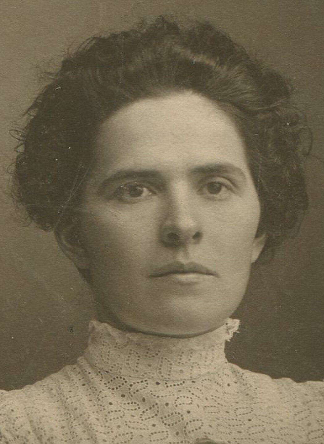 BEAUTIFUL WOMAN WITH RELAXED MESSY HAIR AND RUFFLED DRESS. SILVER PRINT ON CARD.