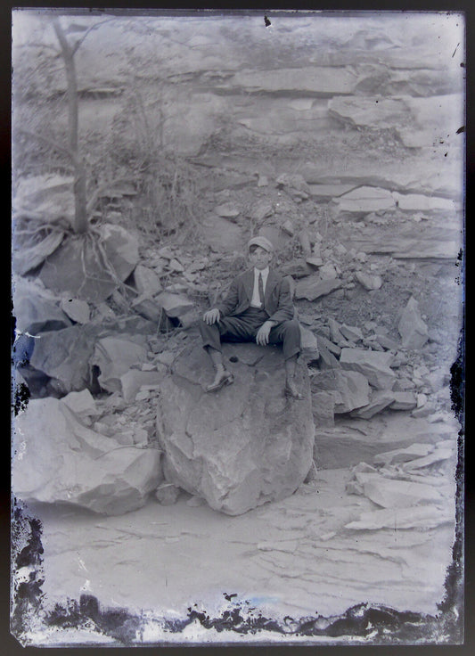 LONELY YOUNG MAN SITTING ON HUGE ROCKS. 5X7 GLASS PLATE NEGATIVE.
