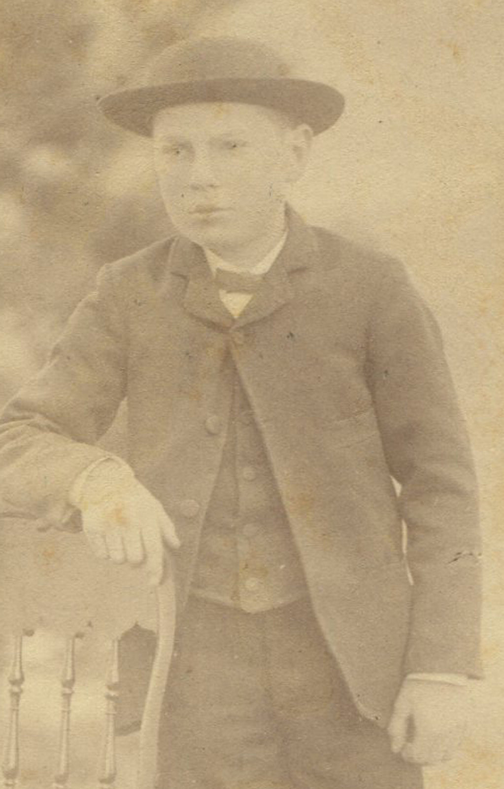 BOY IN HAT POSED STANDING OUTDOORS. CABINET CARD.