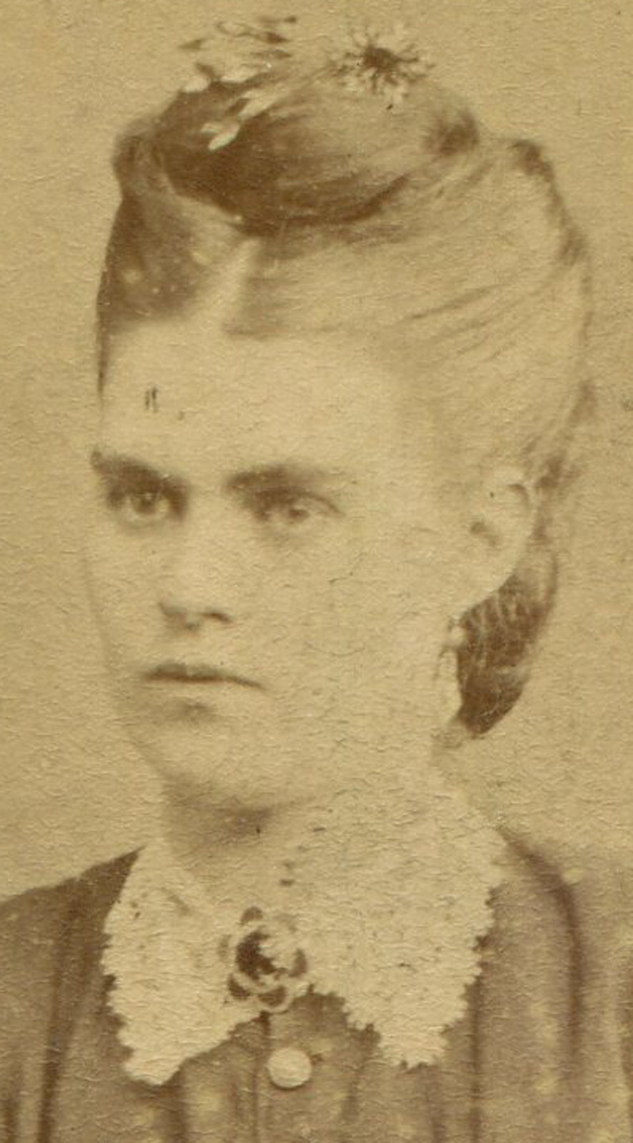 WOMAN WITH SEVERE EXPRESSION AND PILED HIGH HAIR STYLE. GLASGOW, SCOTLAND.