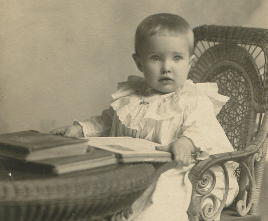 ABSOLUTELY BEAUTIFUL TODDLER POSED READING AT TABLE. SILVER PRINT CIRCA 1900.