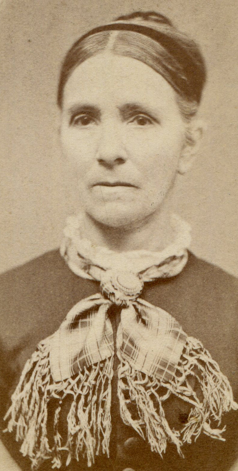 WOMAN, DEEP SET EYES, THIN LIPS, FRAYED PLAID BOW TIE. CDV. WAVERLY, IOWA.