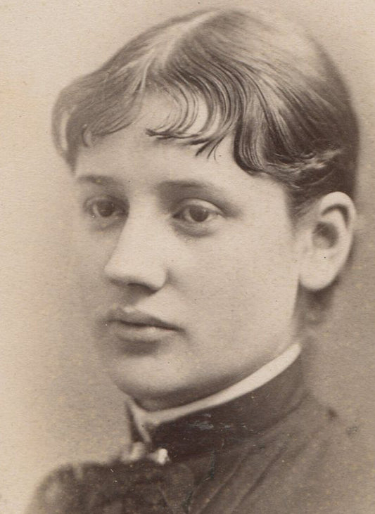 WOMAN WITH WAVY BANGS AND POUTY EXPRESSION. CABINET CARD. BIDDEFORD, ME.