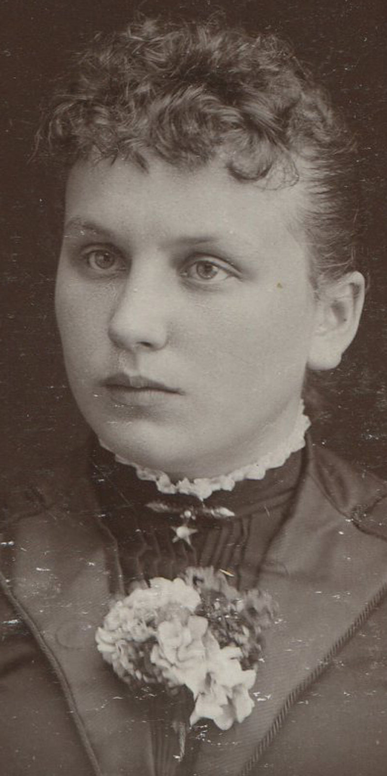 WOMAN, EARNEST EXPRESSION, CORSAGE.  CABINET CARD. STORY CITY, IOWA.