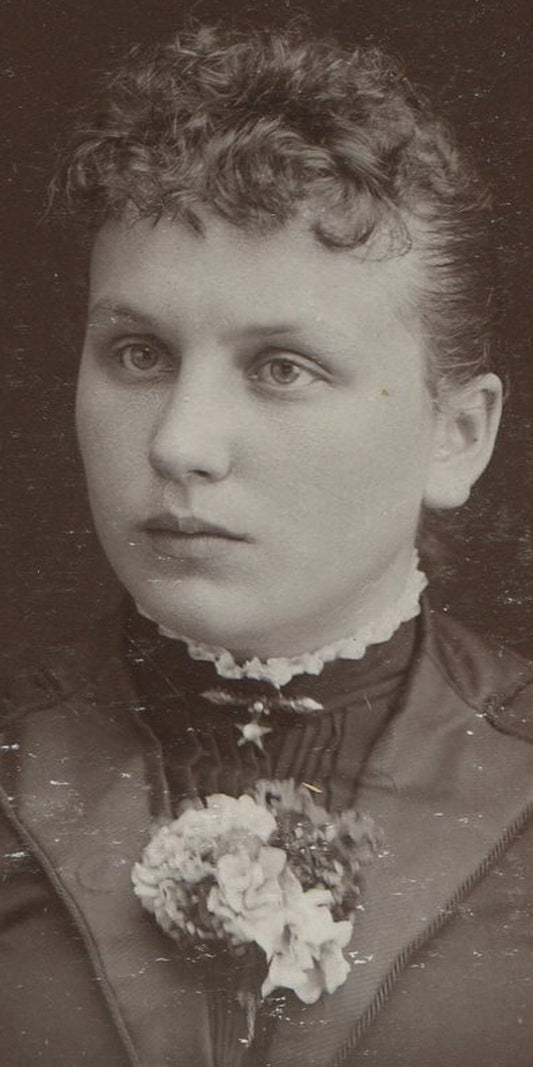 WOMAN, EARNEST EXPRESSION, CORSAGE.  CABINET CARD. STORY CITY, IOWA.