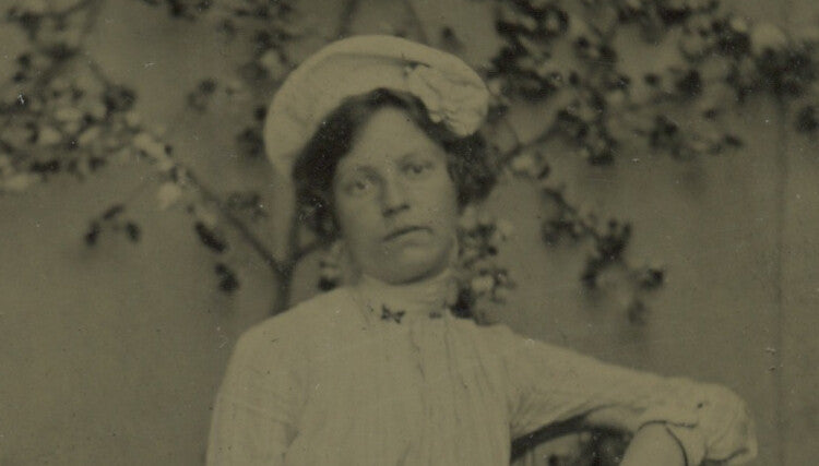 LADY W/ HAT SITTING IN CHAIR, 1/6 PLATE TINTYPE PORTRAIT