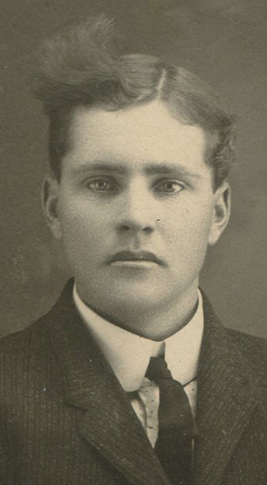 YOUNG MAN WITH CRAZY HAIR STYLE. OVAL SILVER PRINT ON CARD. CIRCA 1900.