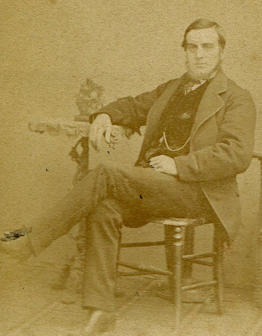SMUGLY CONFIDENT MAN SEATED AT TABLE. CDV. CROYDON, ENGLAND.