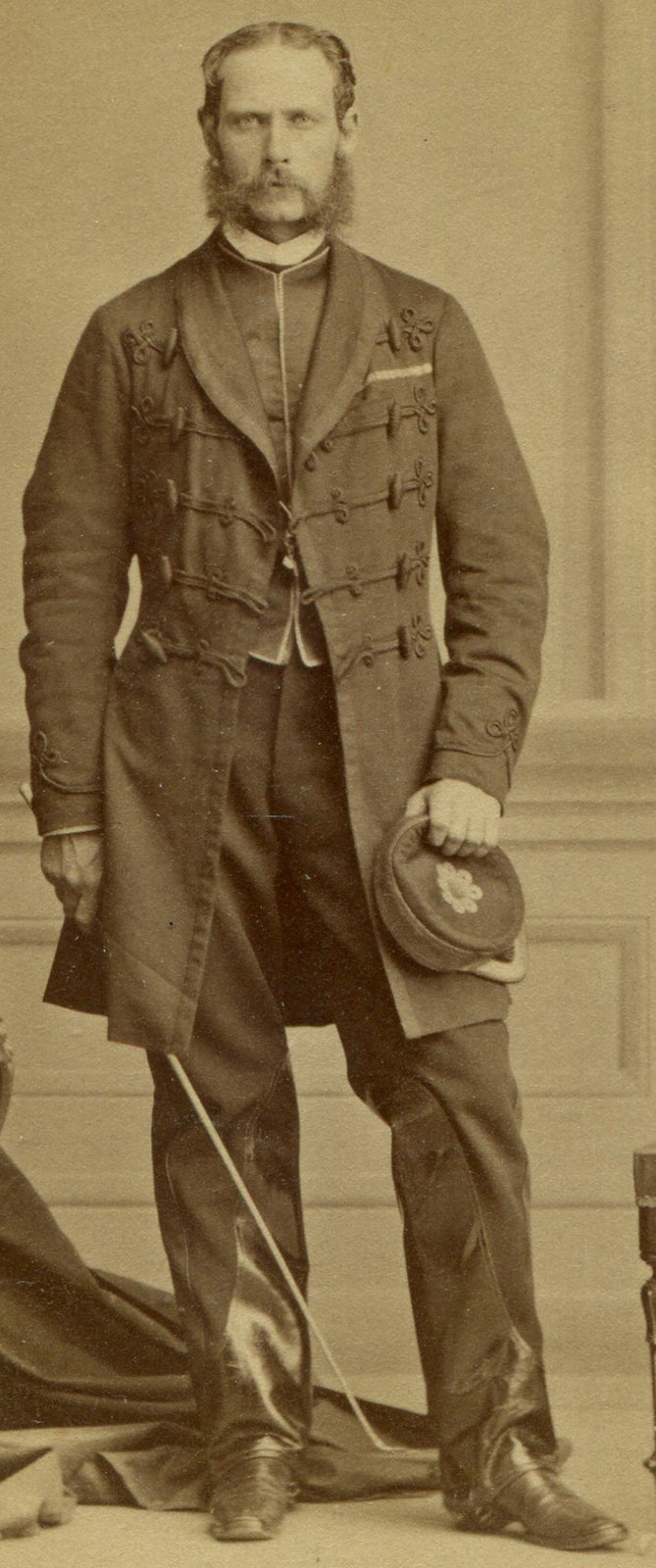 MAN IN ORNATE LONG COAT, KEPI, RIDING CROP, LEATHER TRIMMED PANTS. CDV. MONTREAL