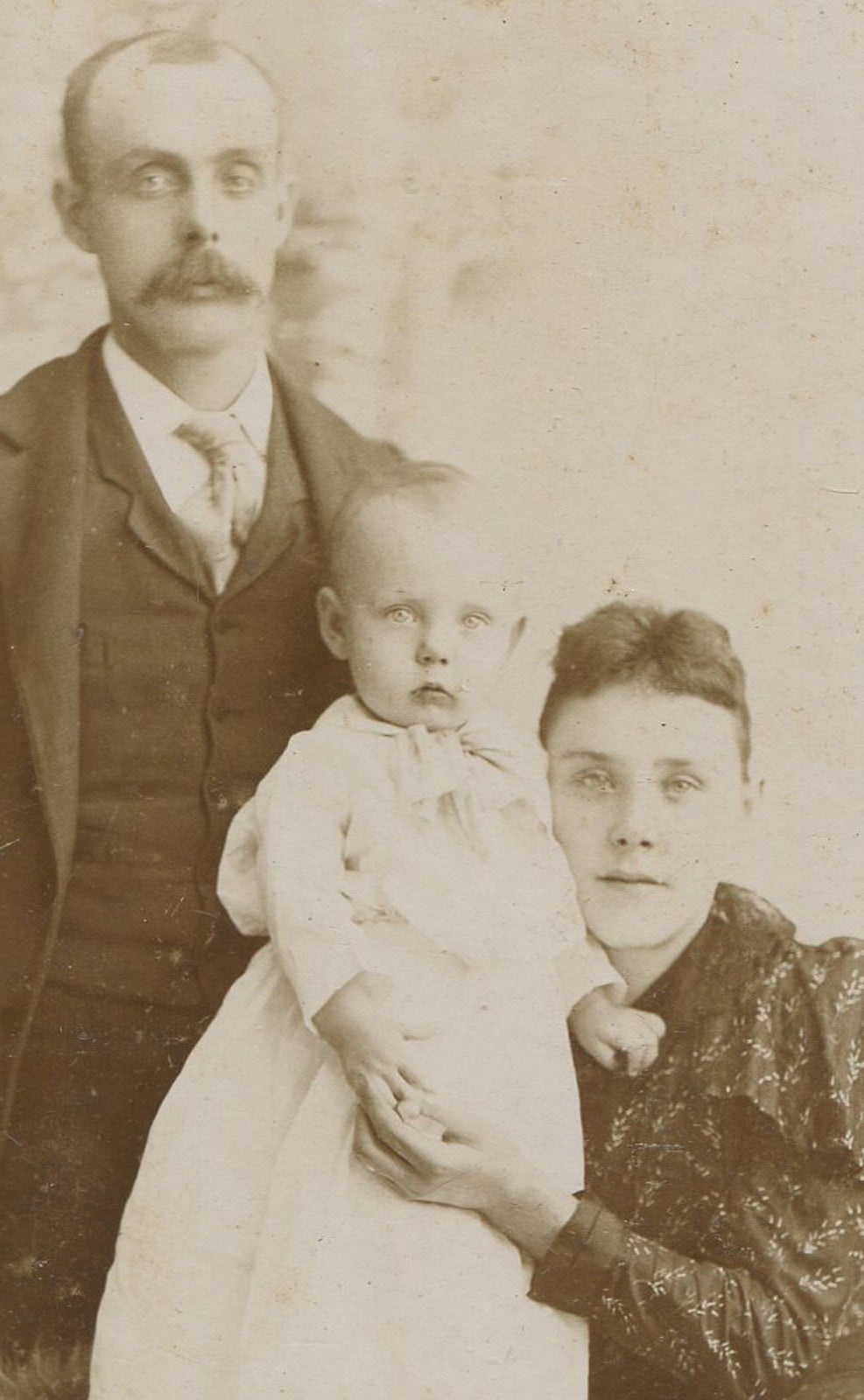 Vintage cabinet card: Parents with adorable baby in affectionate pose - timeless family portrait, early photography