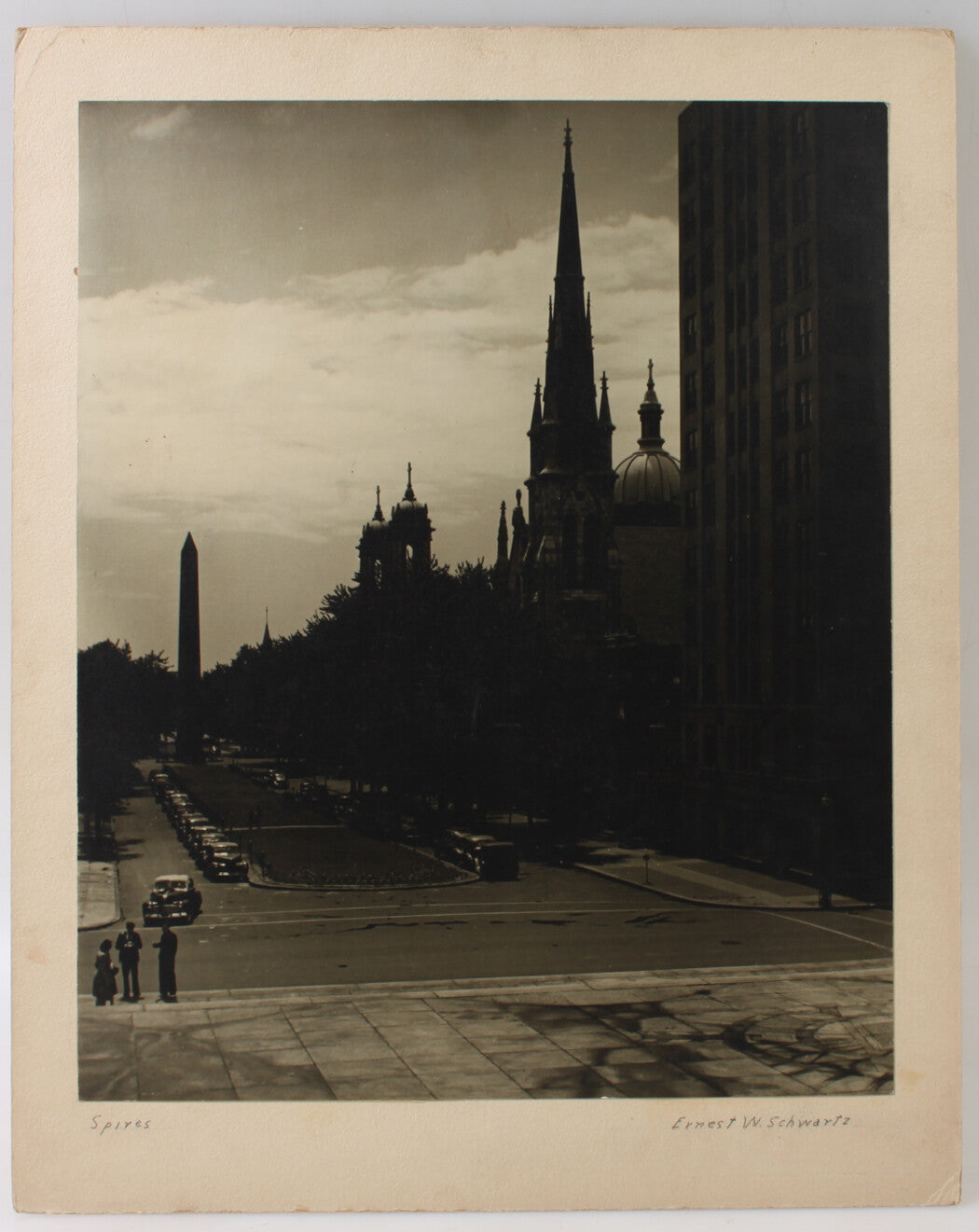 ARCHITECTURAL VIEW, SPIRES ON TREE LINED BOULEVARD. 17 X 14 INCH SILVER PRINT.