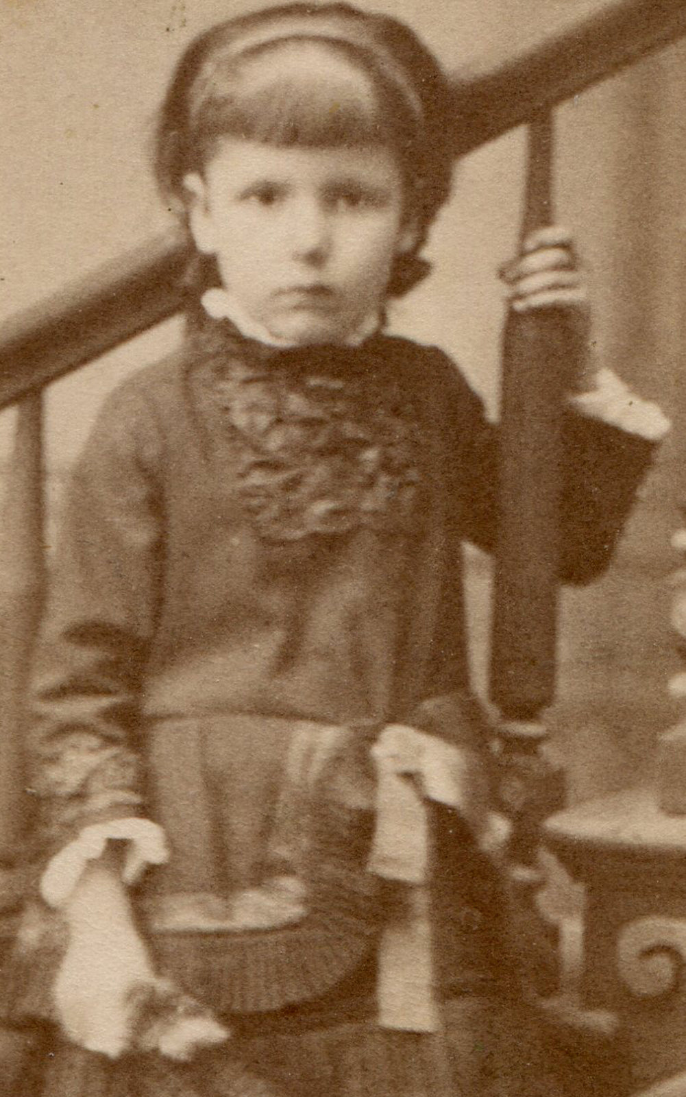 YOUNG GIRL POSED AT STAIRS, HOLDING TOY. CDV.