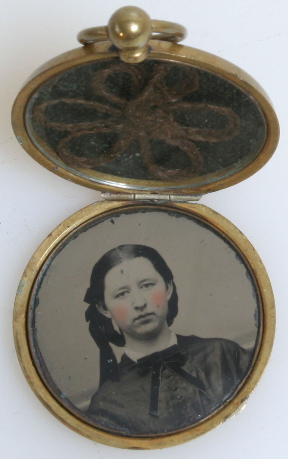YOUNG GIRL IN BRAIDED HAIR. LOCKET JEWELRY, TINTED TINTYPE WITH LOCKET OF BRAID.