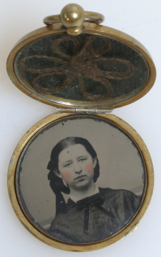 YOUNG GIRL IN BRAIDED HAIR. LOCKET JEWELRY, TINTED TINTYPE WITH LOCKET OF BRAID.