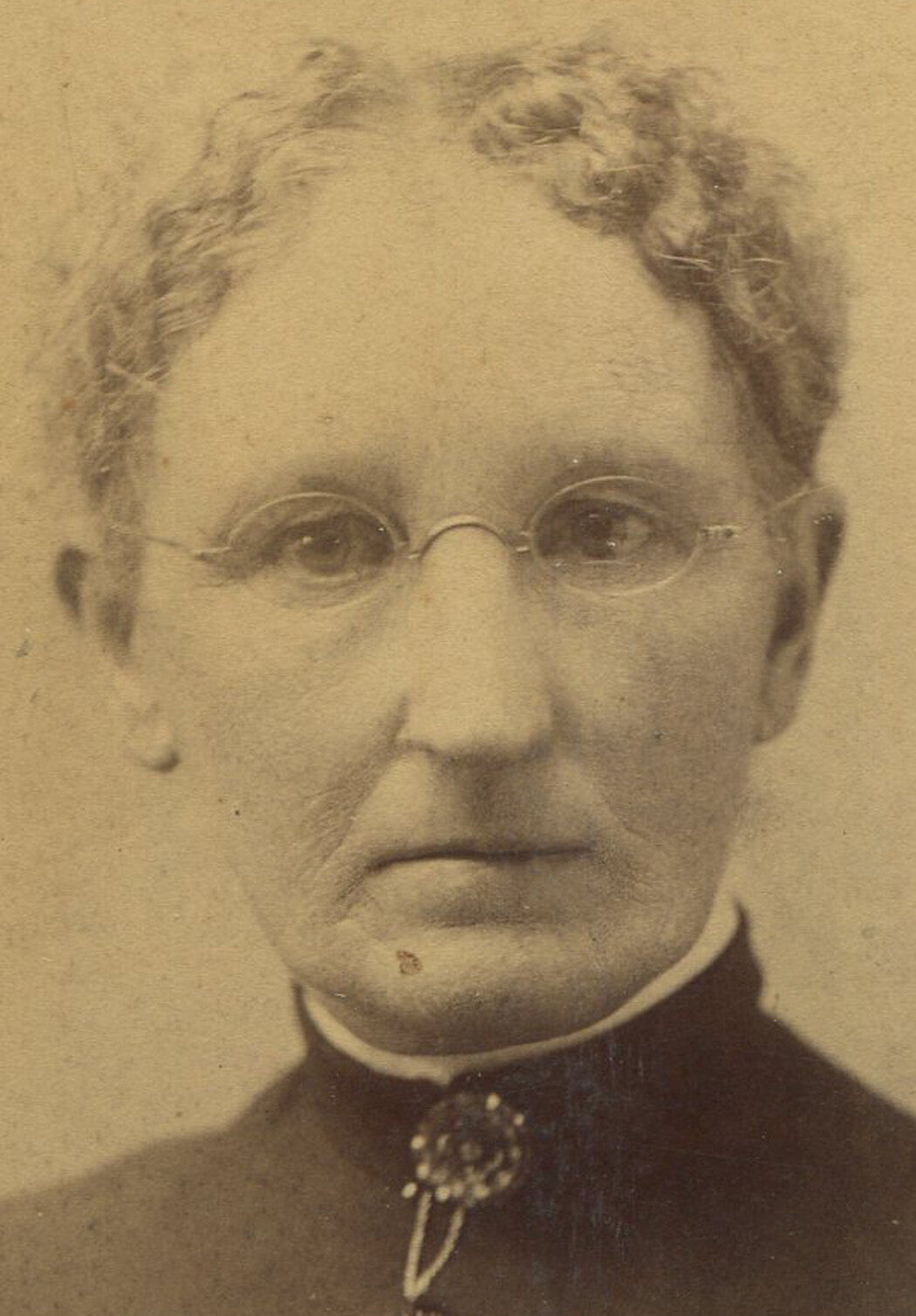 WOMAN W/EYEGLASSES, CRIMPED HAIR AND COLLAR PIN. CABINET CARD.
