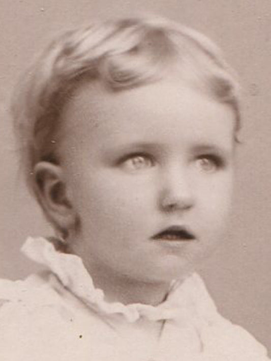 BEAUTIFUL CHILD HOLDING TOY. CABINET CARD. BANCROFT, IOWA.
