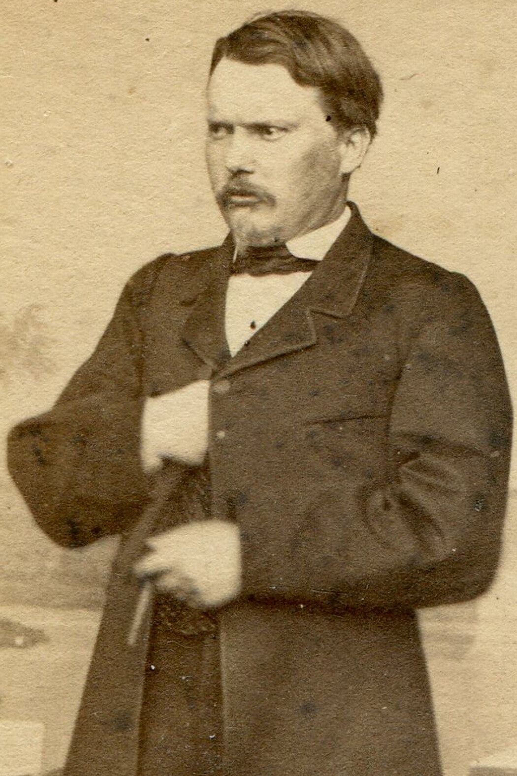 MAN POSED HOLDING CIGAR, REACHING INTO COAT. CDV.