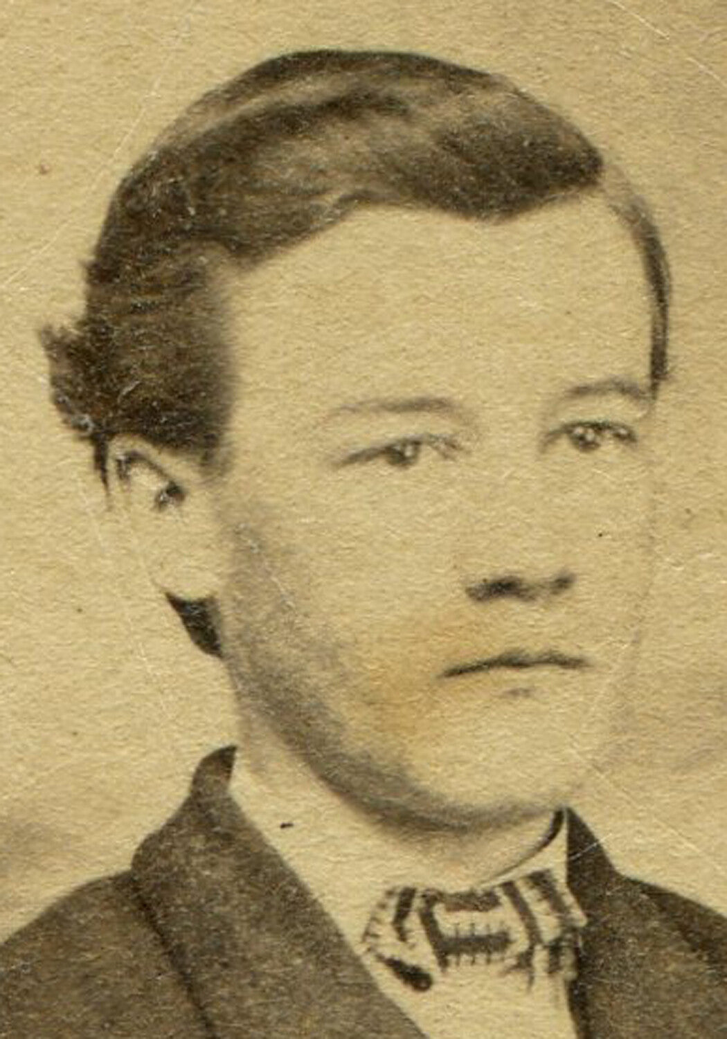 YOUNG MAN SEATED, PAINTED BACKGROUND. CDV.