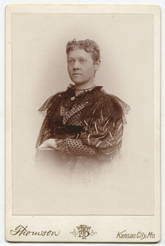 WOMAN IN BUSY PATTERNED DRESS WITH LACE SHOULDER WINGS. CABINET CARD.