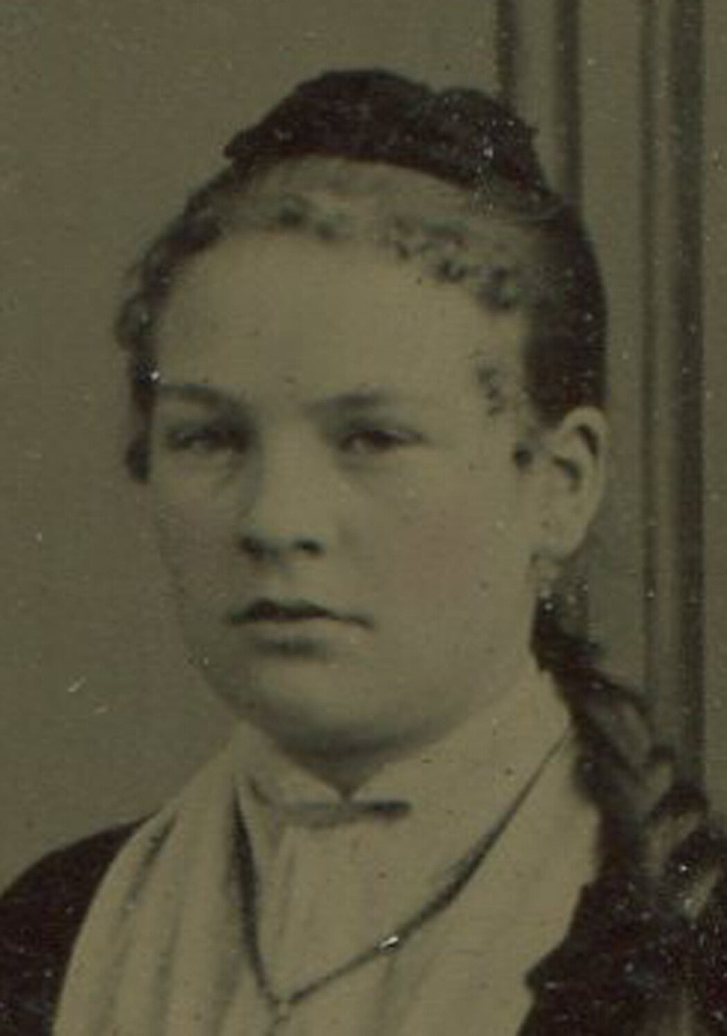 YOUNG WOMAN, SEATED POSE, PIN CURLS, LONG BRAID. PAINTED BACKGROUND TINTYPE.