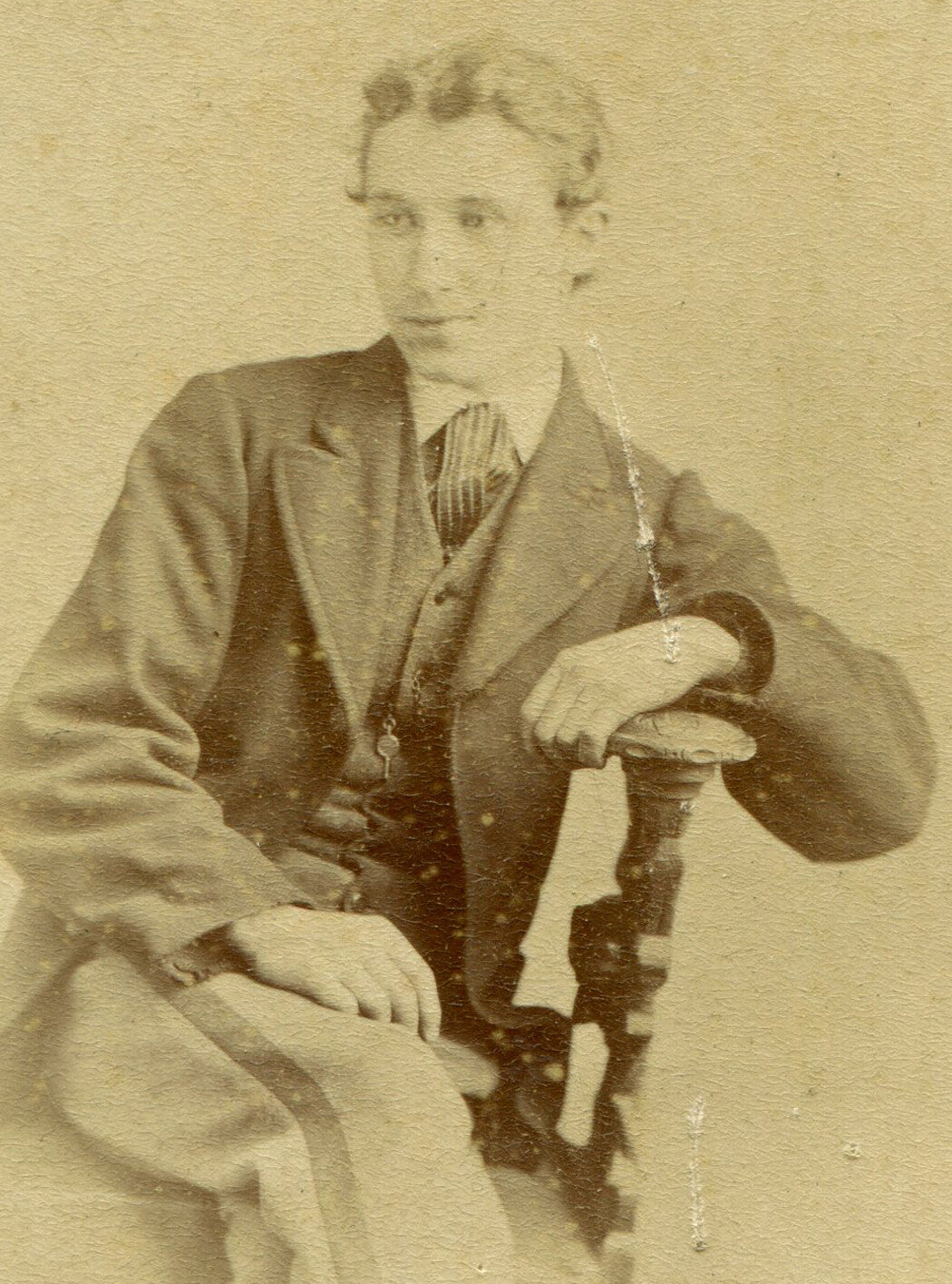 YOUNG MAN IN CASUAL SEATED POSE. GLASGOW, SCOTLAND.