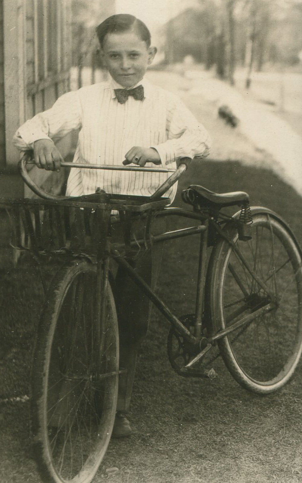 BOY IN BOW TIE, BICYCLE. SILVER PRINT, 1930-40s.