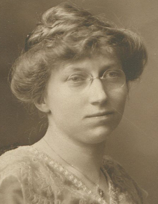 VERY INTELLIGENT LOOKING WOMAN IN GLASSES AND PRETTY DRESS. SEPIA TONED PRINT.