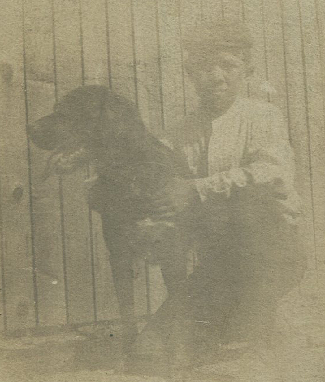A BOY AND HIS DOG. TONED SILVER PRINT ON CARD. 5 X 5 INCHES.