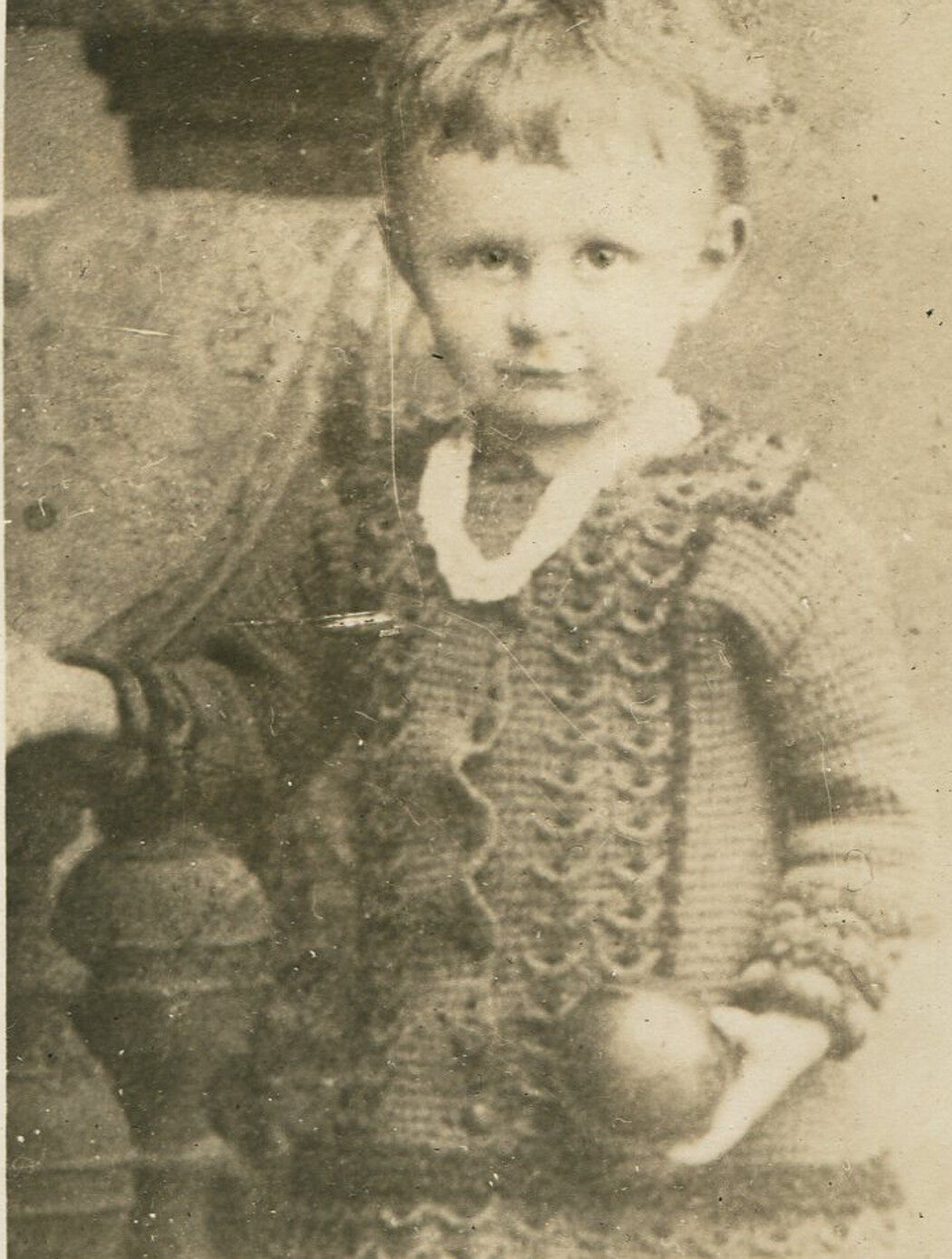 YOUNG GIRL IN KNITTED OUTFIT, POSED HOLDING BALL. 1900, SILVER PRINT.