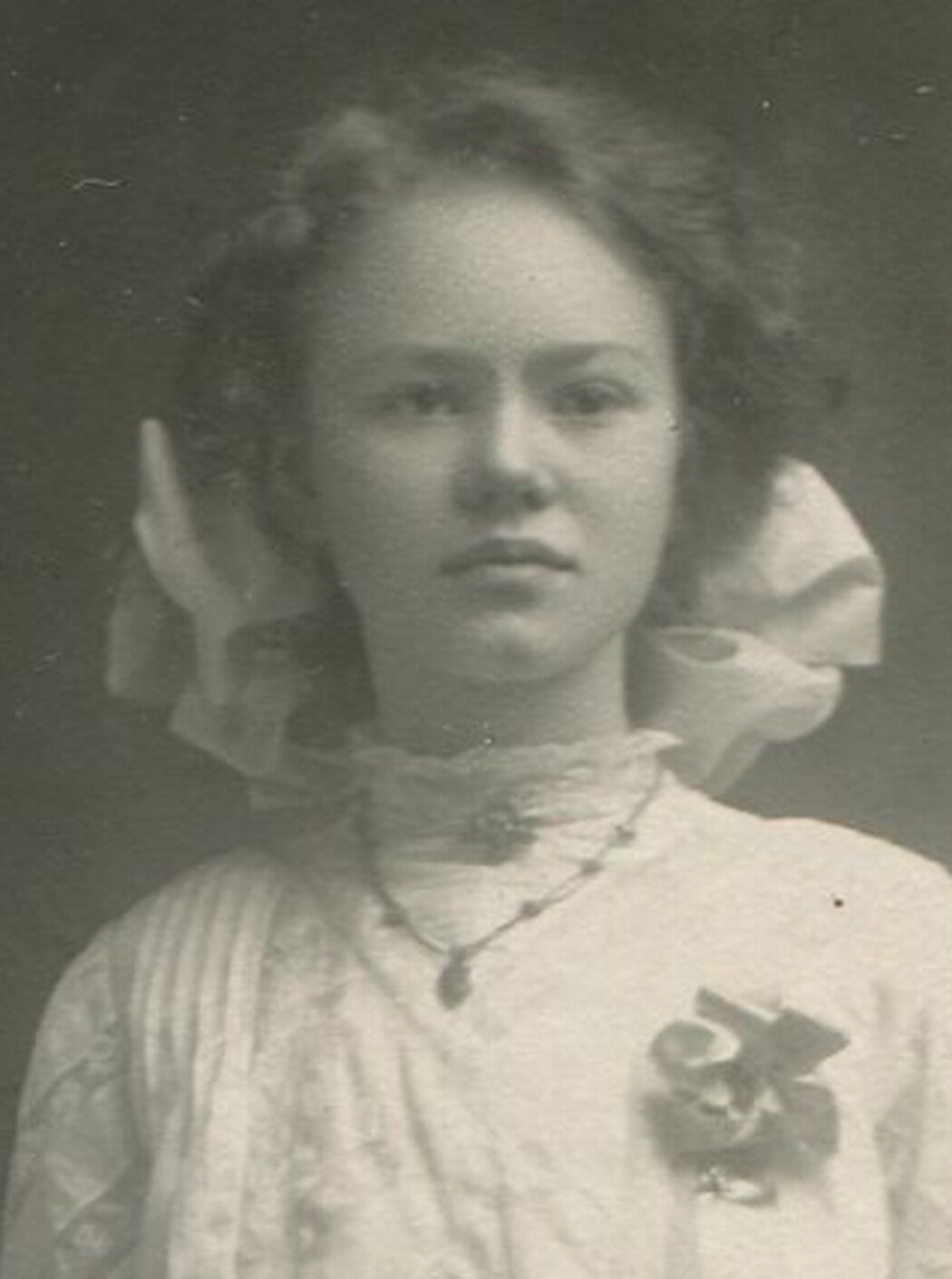 WOMAN W/PINNED AWARD RIBBON, GIFTS AND FLOWERS. SILVER PRINT, 1920s.
