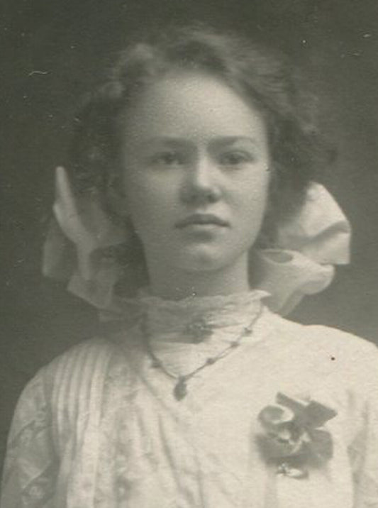 WOMAN W/PINNED AWARD RIBBON, GIFTS AND FLOWERS. SILVER PRINT, 1920s.