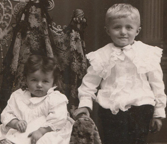 YOUNG SIBLINGS, ONE SEATED WITH PHOTOS. THEY LOOK LIKE TROUBLE. CABINET CARD.