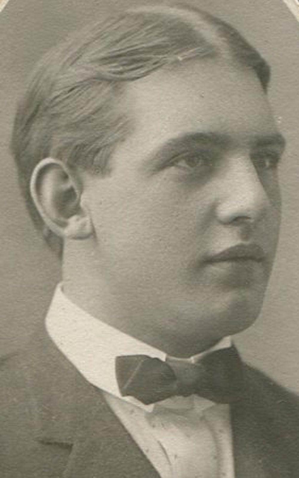 YOUNG MAN WITH HANDSOME PROFILE, BOW TIE. OVAL SILVER PRINT ON TRIMMED EMBOSSED