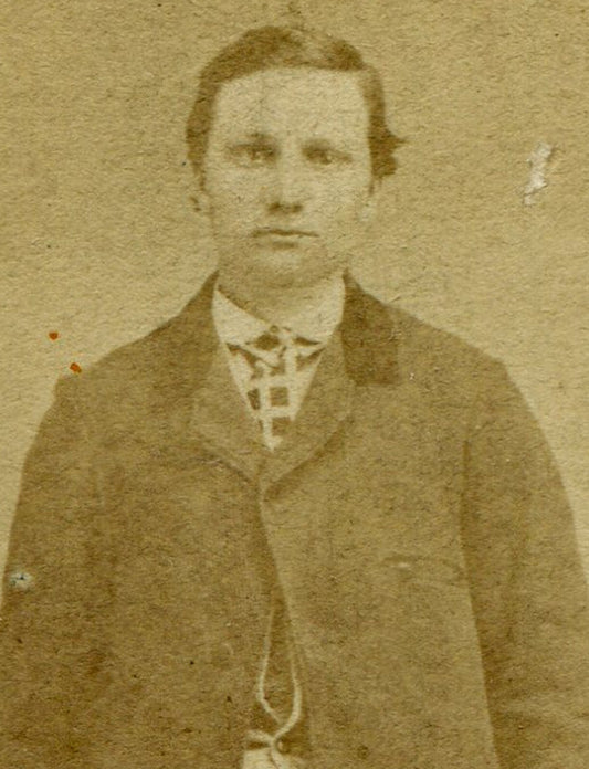 VERY TALL MAN, STANDING POSE, NEXT TO SMALL CHAIR. CDV.