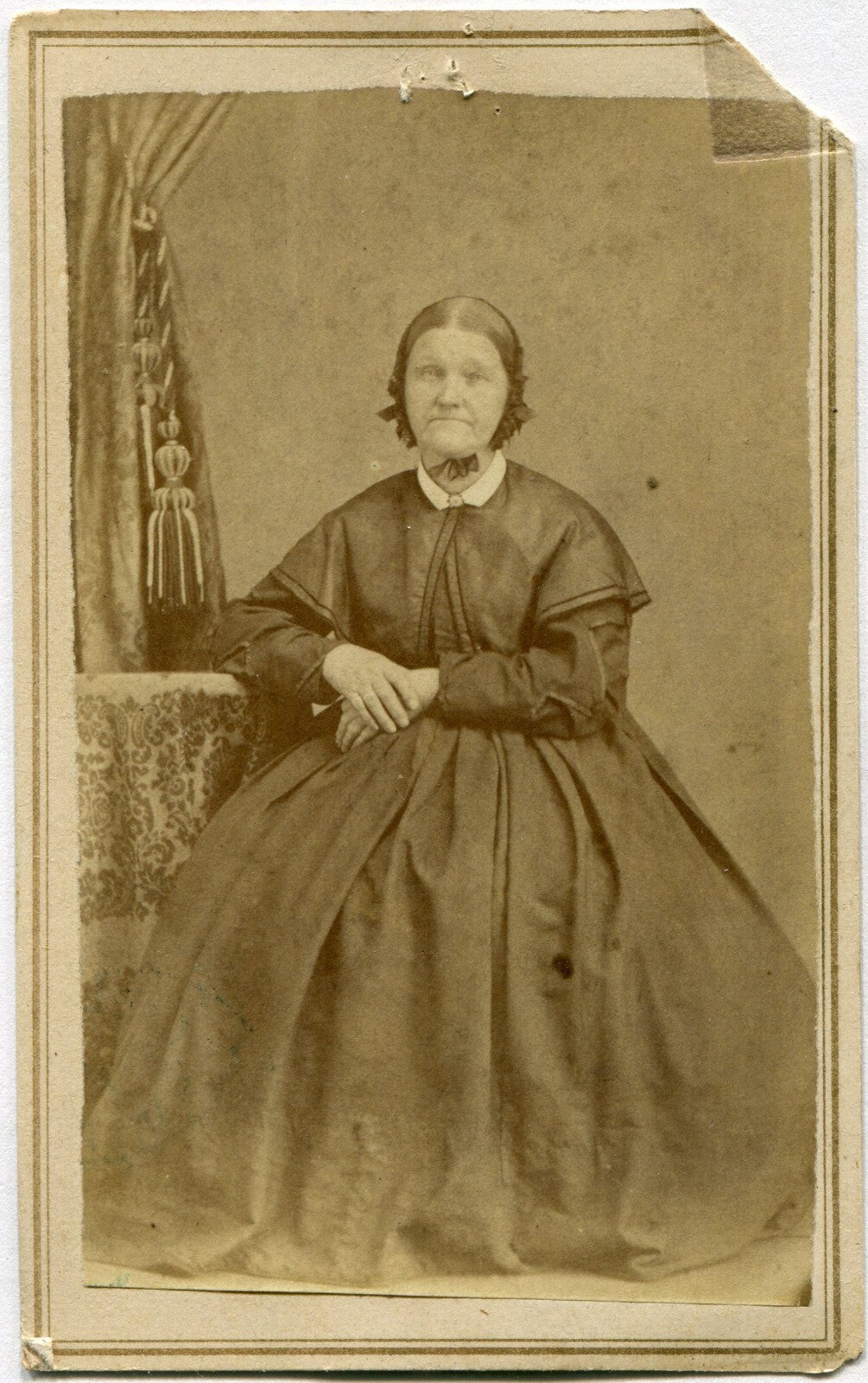 WOMAN IN BONNET, CROSSED HANDS, DEEP SET SAD EYES. CDV.